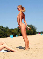 A busty bikini bitch undressing on the Trunk Bay Image 3