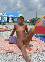 A busty bikini slut undressing on the Hanauma Image 9