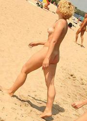 A busty bikini bitch undressing on the Natadola Image 2