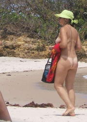A busty bikini slut undressing on the Coralita Image 4
