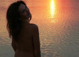 My sexy girlfriend with cute tiny boobies prefers swimming nude on a lonely beach at sunset. Image 4