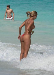 A busty bikini slut undressing on the Cap d'Agde Image 3
