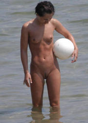 A busty bikini slut undressing on the Cap d'Agde Image 10